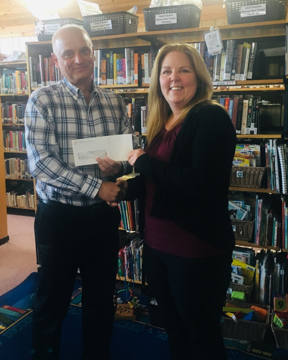 Hornepayne Public Library CEO Darnelle Hill accepting donation from Society of United Professionals' NWMO Local